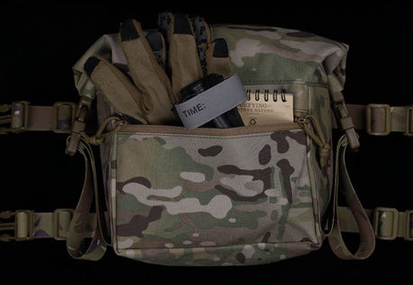 Erebus Industries MKII Expansion Pack Front Item Display in multicam pattern, front pocket zipper open highlighting storage of admin pouch, equipment inserted into pouch gloves, tourniquet, and note pad