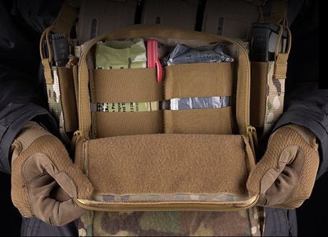 erebus industries MKII Chest Rig in multicam pattern, front view close up, highlighting integrated admin pouch, showing internal organization of admin pouch, medical equipment inserted into elastic loops inside of admin pouch, front zipper open and folded down